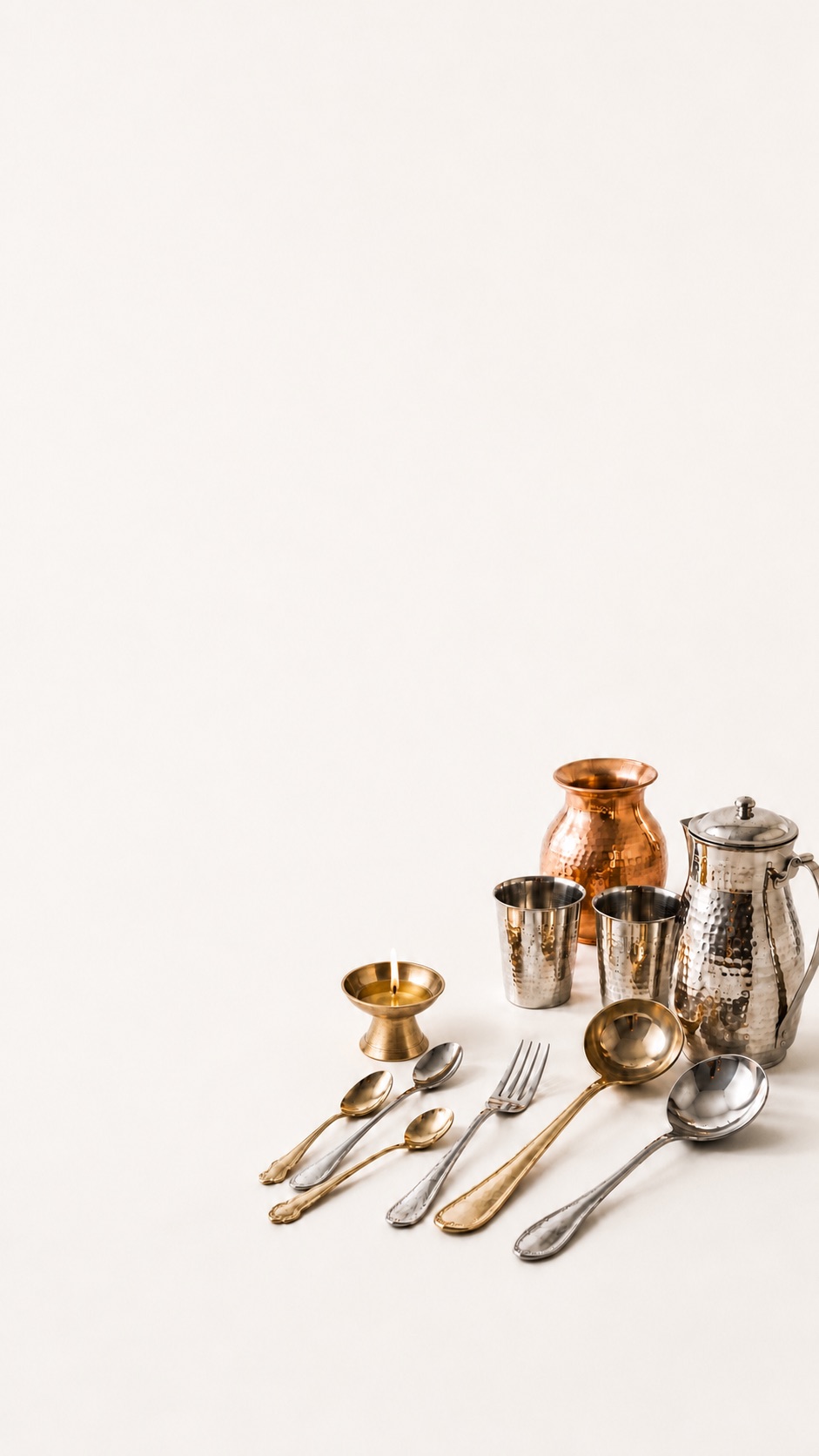 Brass, copper, stainless steel and bronze metalware: diya, lota, glasses, jug and cutlery
